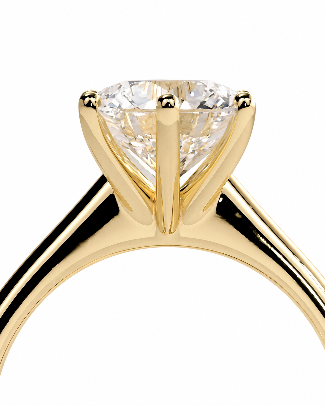 color_10K_YG, color_14K_YG &&A close-up of a yellow gold solitaire engagement ring featuring a round brilliant-cut diamond set in a four-prong setting, shown against a solid white background.