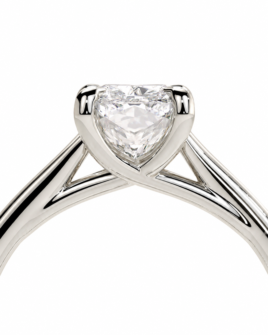 color_925_SIL,color_935_ARG,color_10K_WG, color_14K_WG &&A close-up studio shot of a silver engagement ring featuring a heart-shaped clear gemstone in a four-prong setting, with a split shank band on a plain white background.