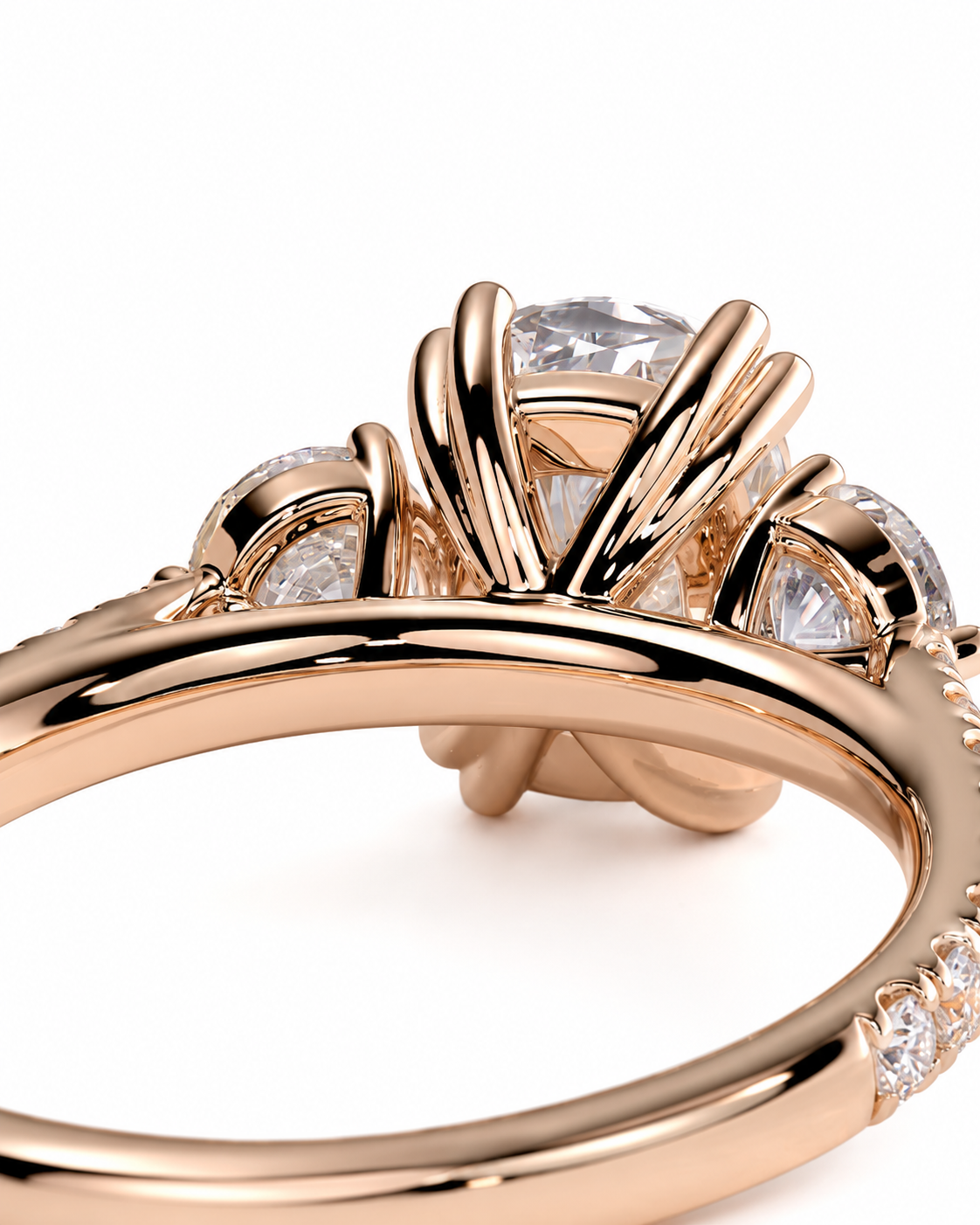 color_10K_RG, color_14K_RG &&Rose gold ring with a large clear round center stone and smaller clear stones along the shoulders, photographed on a clean white background.