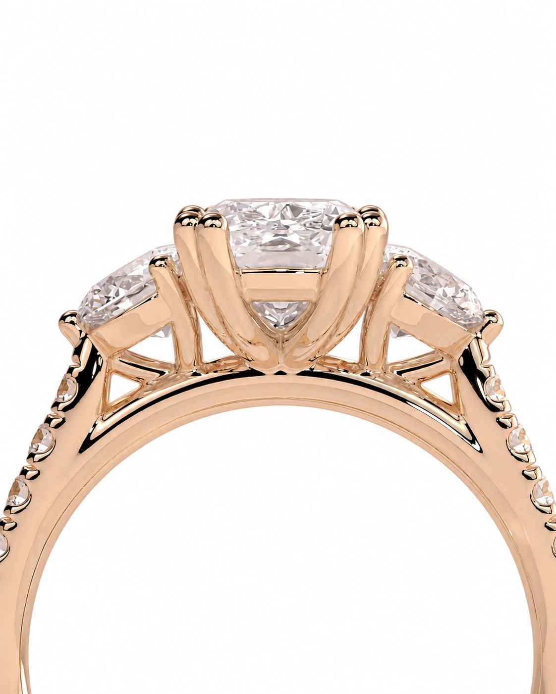 color_10K_RG, color_14K_RG &&A close-up of a rose gold ring featuring a princess-cut center diamond and three round side diamonds in a three-stone setting, on a plain white background.