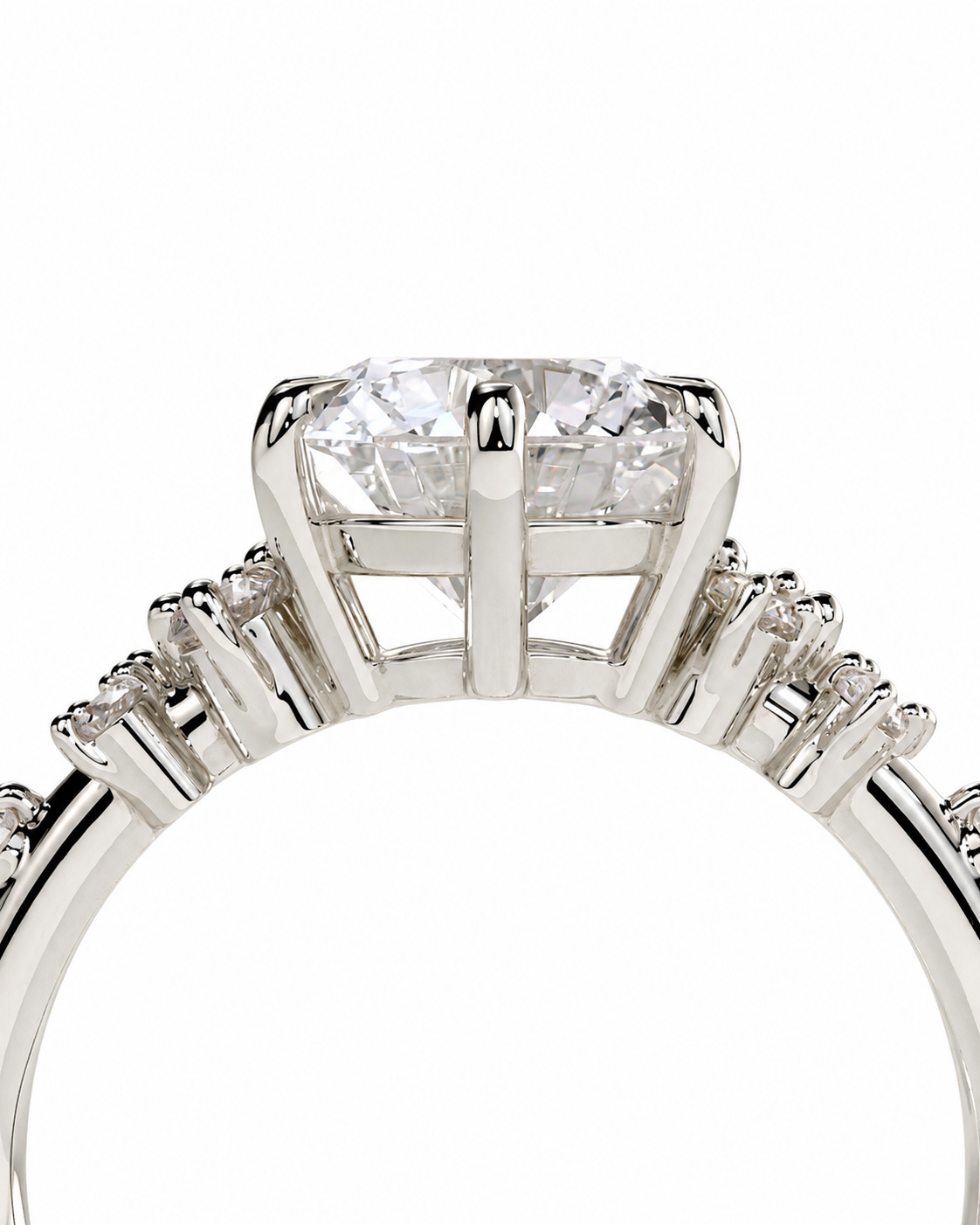 color_925_SIL,color_935_ARG,color_10K_WG, color_14K_WG &&Close-up of a silver-toned diamond ring with a large round center stone and smaller diamonds along the band, shown against a plain white background.