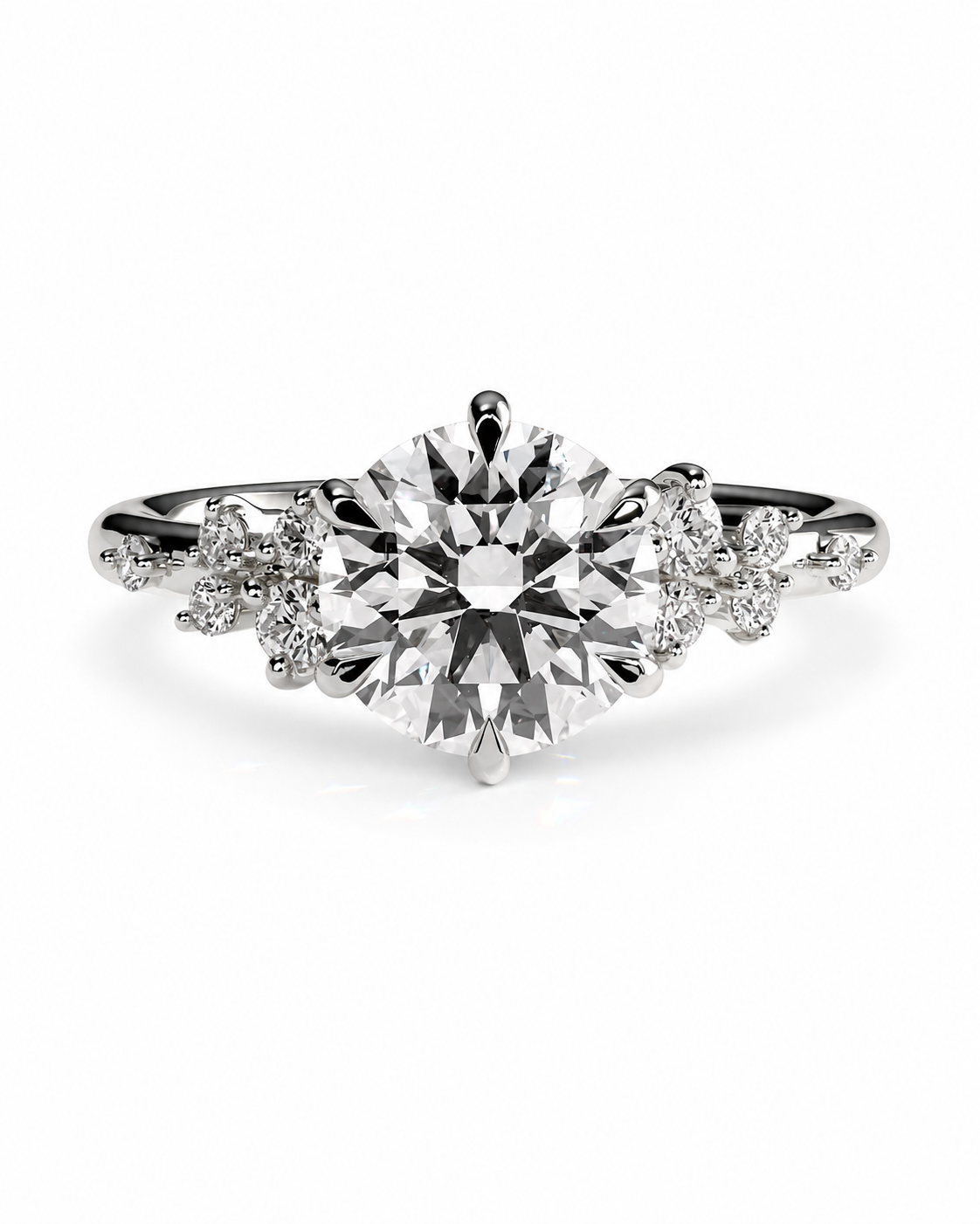 color_925_SIL,color_935_ARG,color_10K_WG, color_14K_WG &&A silver-tone diamond engagement ring featuring a large round-cut center stone and smaller diamonds along the shoulders, set against a clean white background.