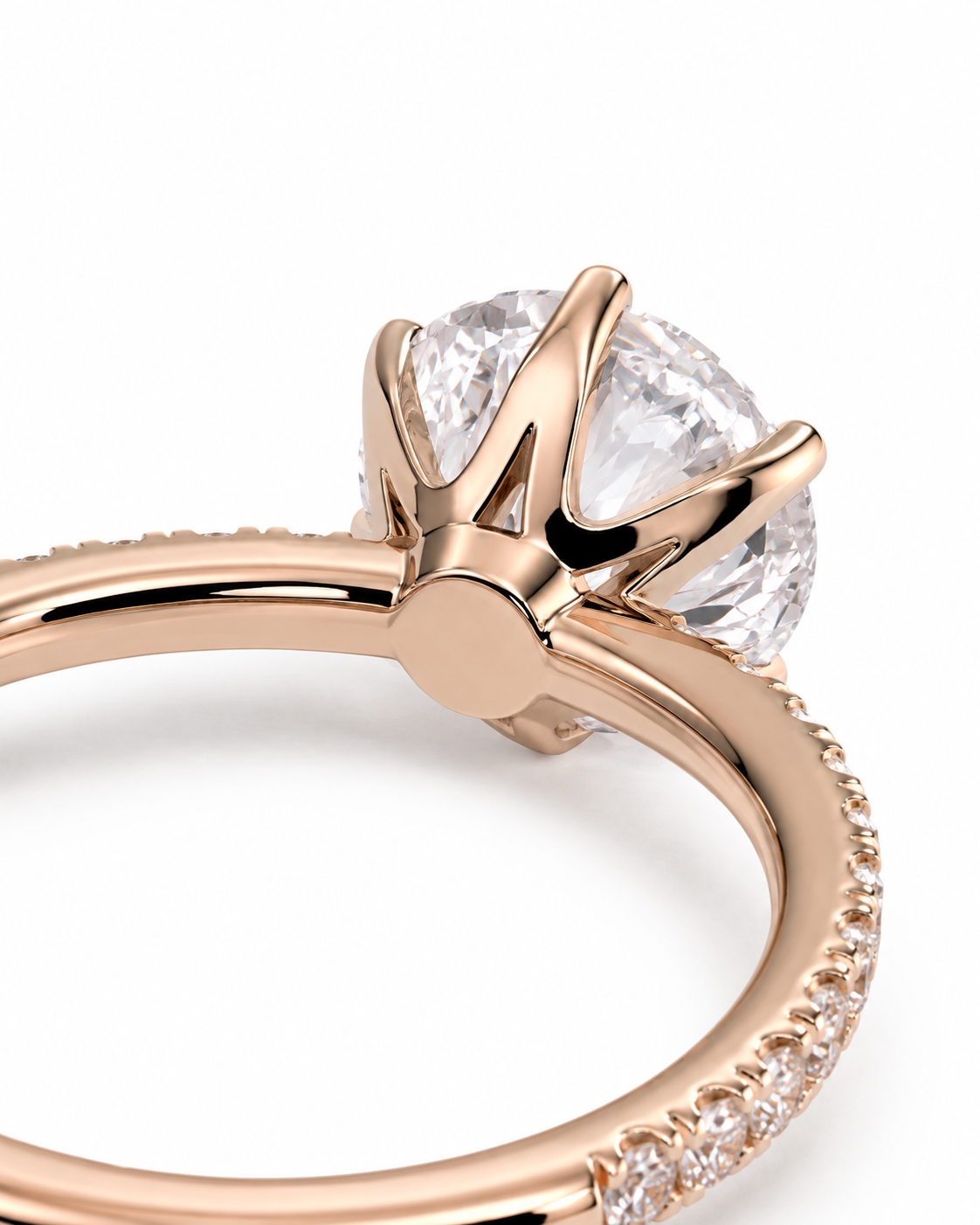 color_10K_RG, color_14K_RG &&Close-up of a rose gold ring featuring a crown-like setting with a large clear round gemstone and small pavé accents along the band, shown on a white background.