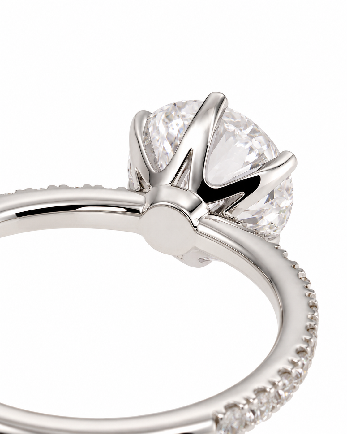 color_925_SIL,color_935_ARG,color_10K_WG, color_14K_WG &&Close-up of a silver-toned diamond engagement ring with a brilliant round-cut center stone and a pavé band on a white background.