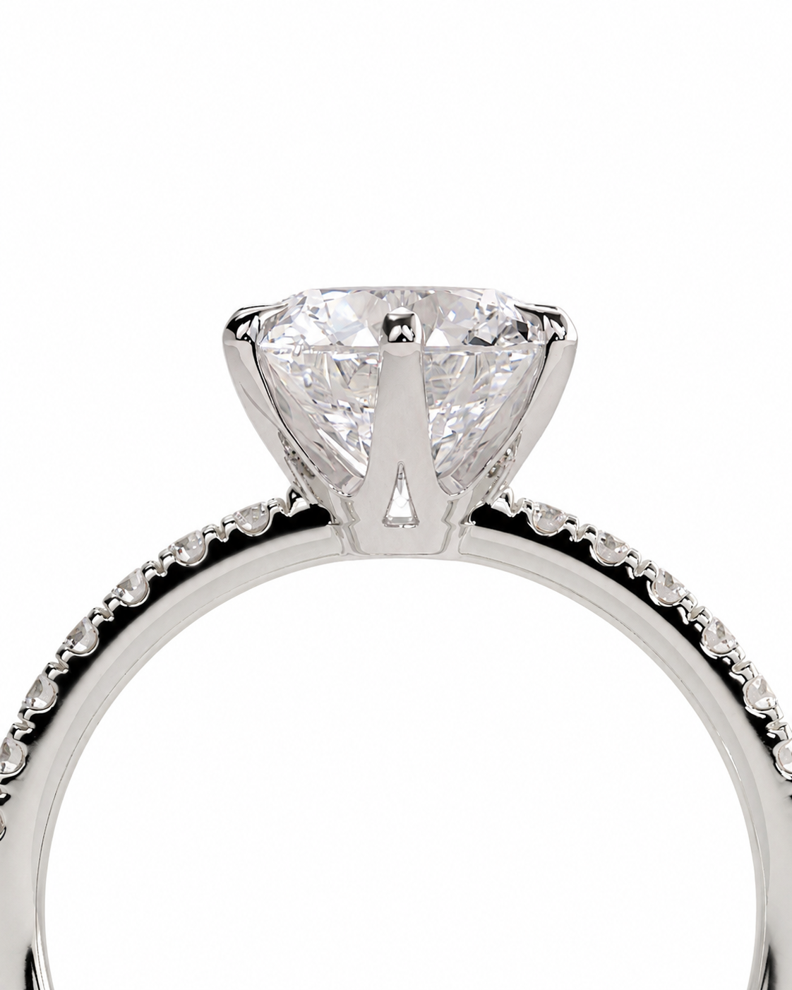 color_925_SIL,color_935_ARG,color_10K_WG, color_14K_WG &&A close-up studio shot of a diamond engagement ring featuring a large round brilliant-cut center stone in a four-prong setting, with a pavé diamond band in a silver-colored metal, set against a plain white background.