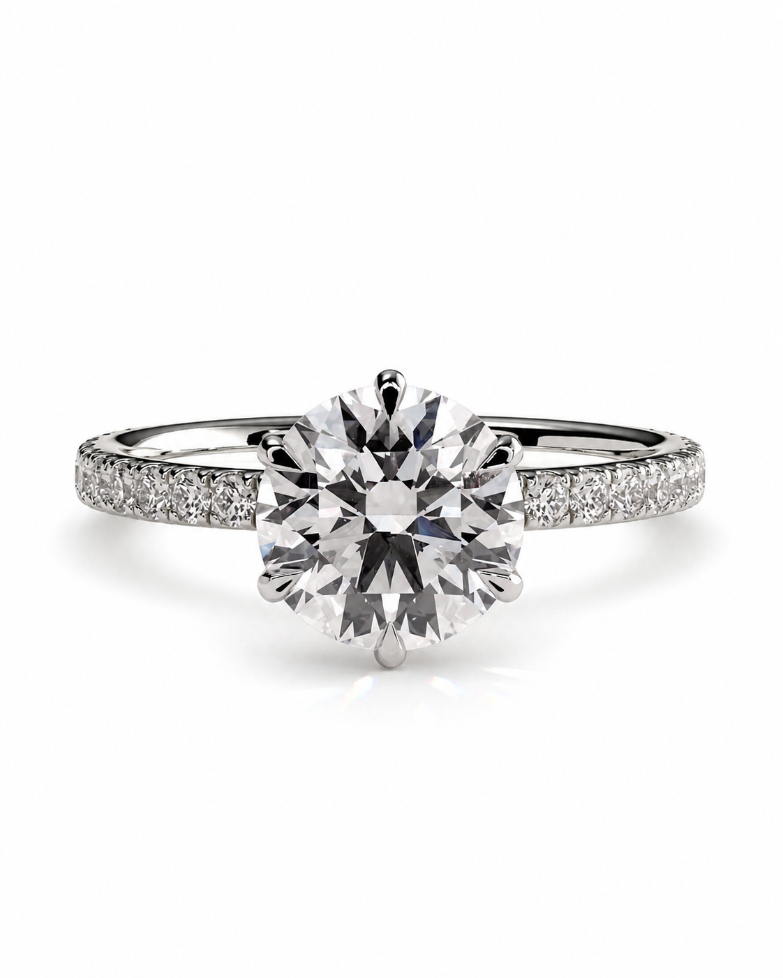 color_925_SIL,color_935_ARG,color_10K_WG, color_14K_WG &&A radiant-cut diamond engagement ring with a brilliant solitaire center stone and a pavé-set diamond band in a silver-colored metal, shown on a clean white background.