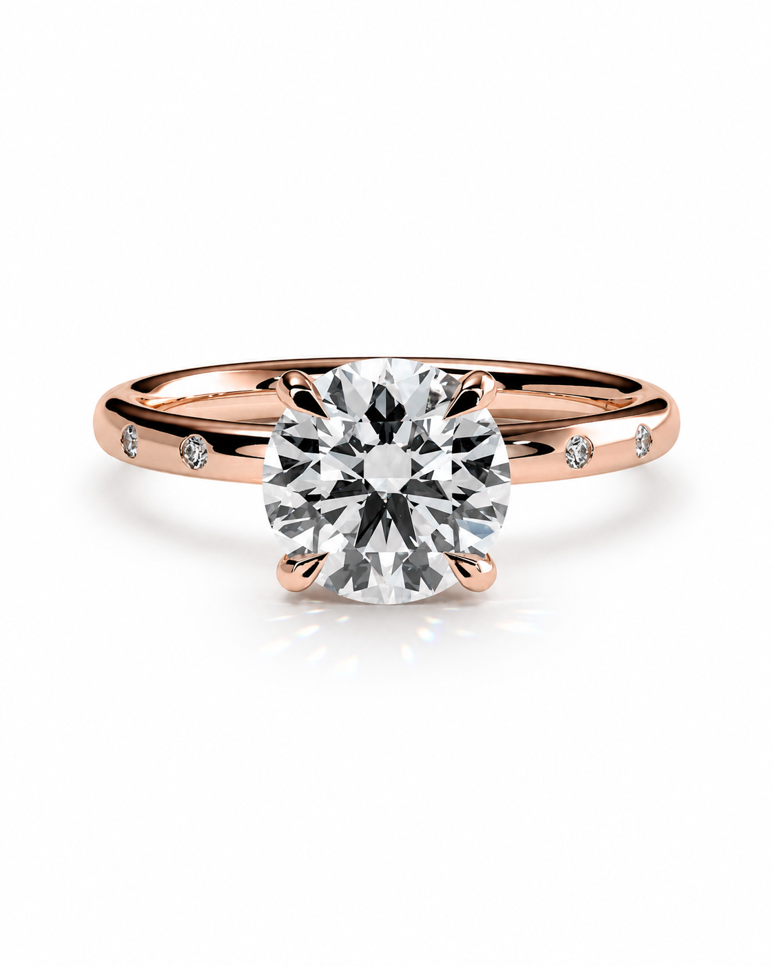 color_10K_RG, color_14K_RG &&A rose gold solitaire engagement ring with a round brilliant-cut center stone and small accent stones on the band, set against a clean white background.