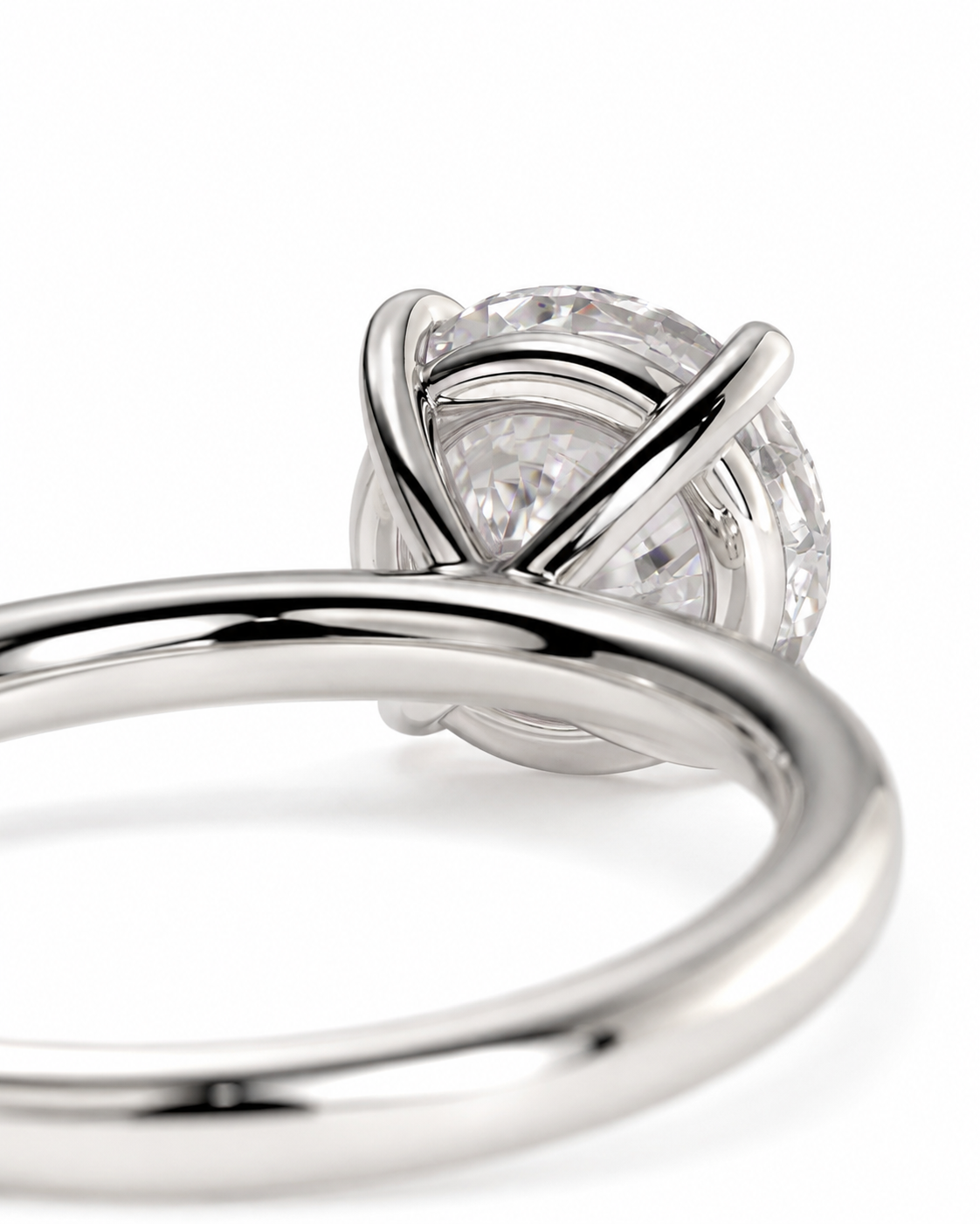 color_925_SIL,color_935_ARG,color_10K_WG, color_14K_WG &&A close-up shot of a silver-toned ring featuring a round clear gemstone in an intricate, interlocking wrap-style setting, shown against a seamless white background.