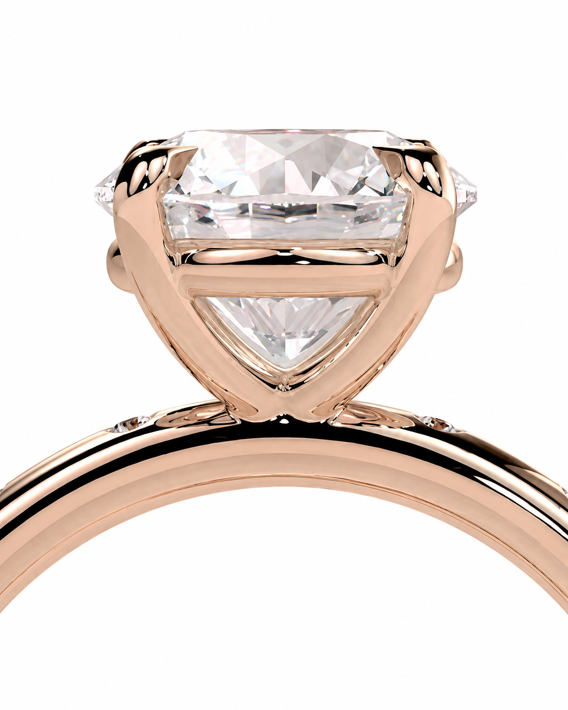 color_10K_RG, color_14K_RG &&A close-up of a rose gold solitaire engagement ring featuring a large, brilliant-cut clear gemstone in a prong setting, shown against a solid white background.
