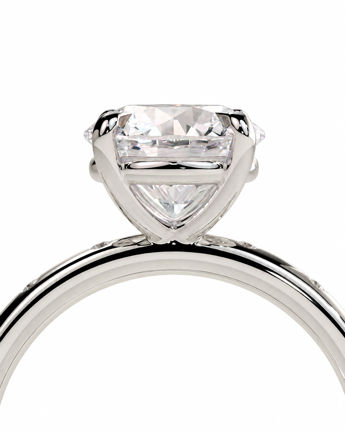 color_925_SIL,color_935_ARG,color_10K_WG, color_14K_WG &&A close-up studio shot of a solitaire engagement ring featuring a large round brilliant-cut diamond set in a polished silver-colored metal band, isolated on a white background.