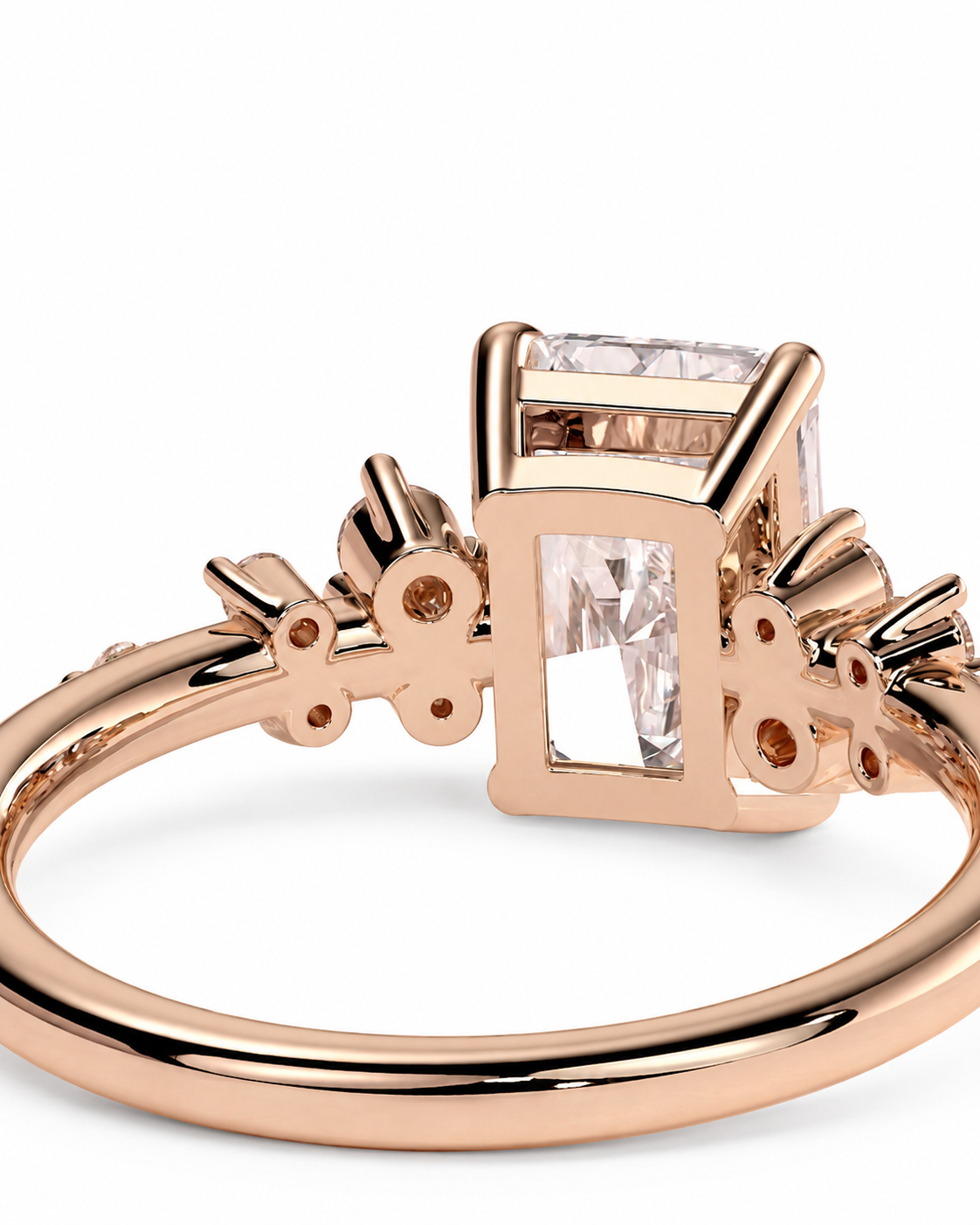 color_10K_RG, color_14K_RG &&Rose gold ring with a rectangular clear gemstone in a square setting, accented with small round stones on the band, shown on a white background.