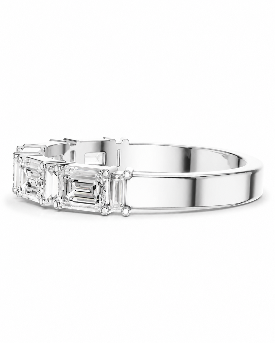 color_925_SIL,color_935_ARG,color_10K_WG, color_14K_WG &&A silver-toned band ring featuring three baguette-cut clear gemstones on the left side, set against a plain white background.
