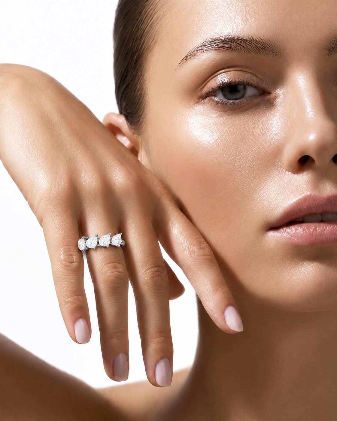 color_925_SIL,color_935_ARG,color_10K_WG, color_14K_WG &&A close-up lifestyle shot of a model wearing a silver ring with three small clear stones on her finger, set against a clean white background.