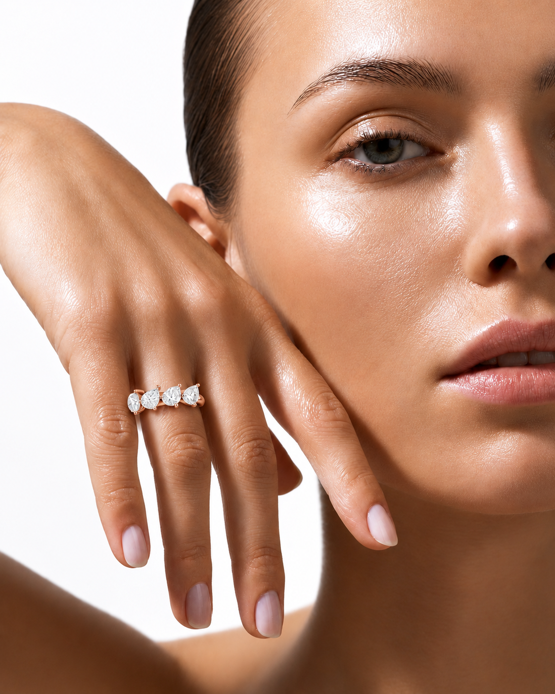 color_10K_RG, color_14K_RG &&A close-up lifestyle shot of a model wearing a delicate gold ring with three small clear round-cut gemstones on her ring finger, set against a clean white background.