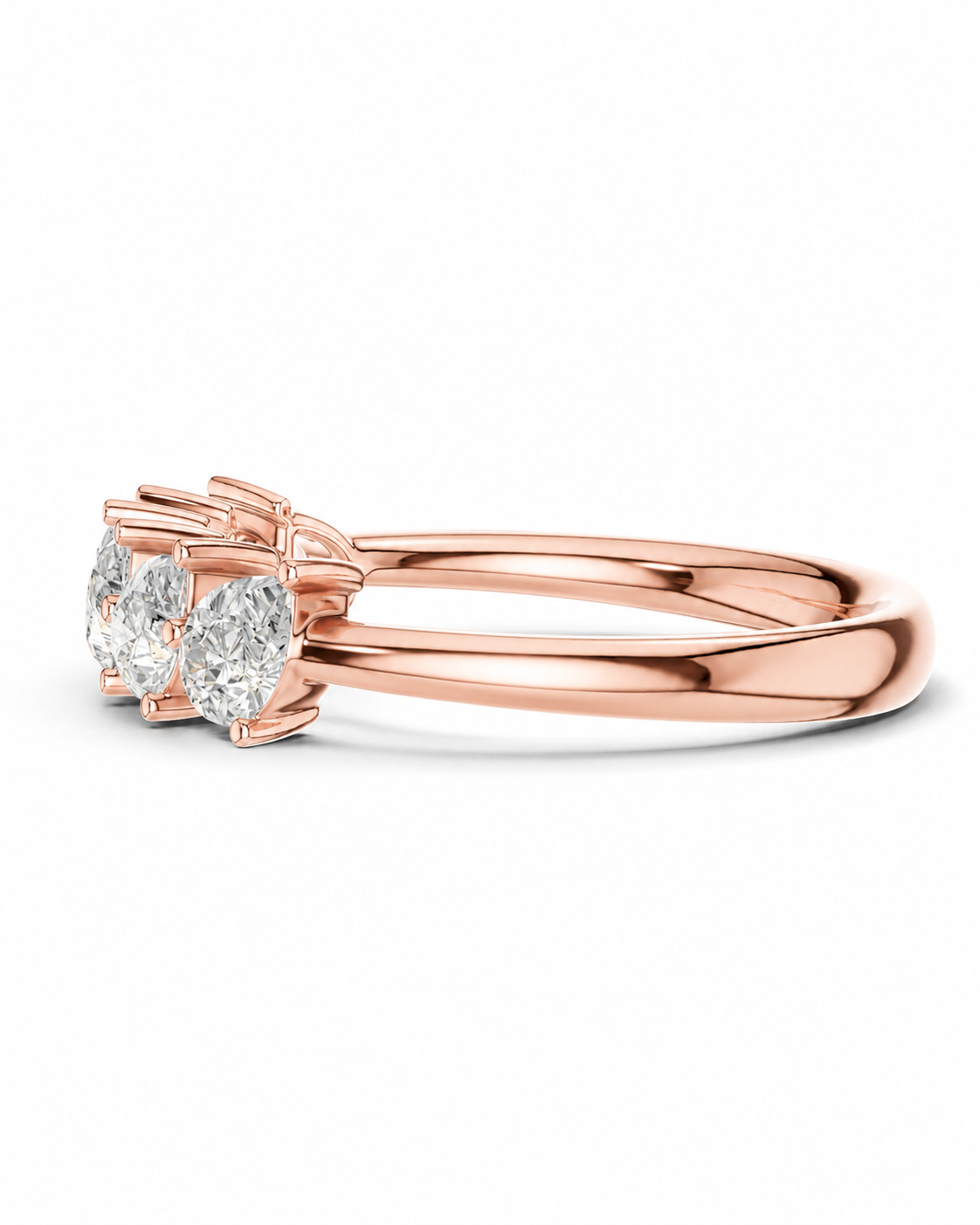 color_10K_RG, color_14K_RG &&A rose gold ring featuring three round-cut clear gemstones in a prong setting, shown on a clean white background.