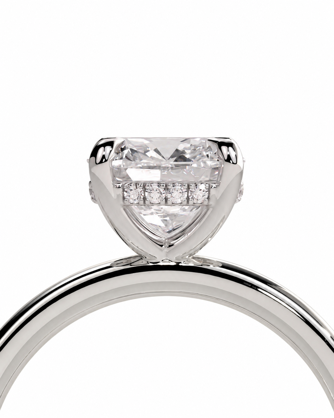 color_925_SIL,color_935_ARG,color_10K_WG, color_14K_WG &&A close-up studio shot of a silver-toned ring featuring a large heart-shaped clear gemstone in a prong setting, with a row of smaller round stones along the band, on a plain white background.