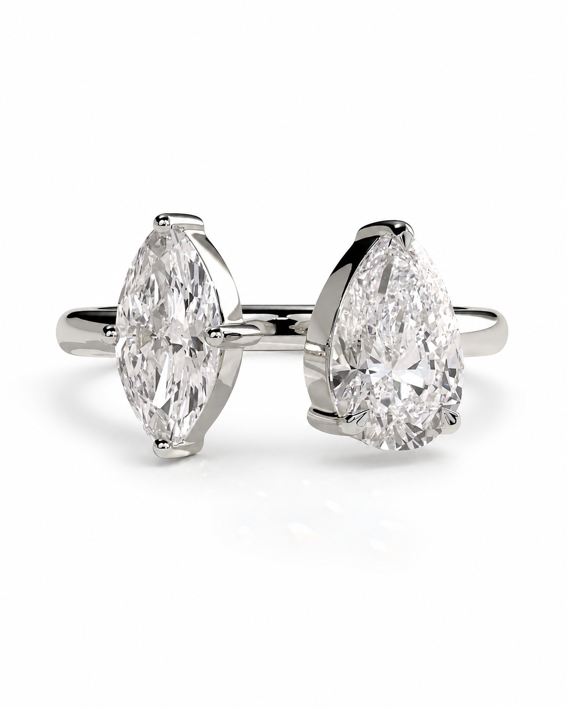 color_925_SIL,color_935_ARG,color_10K_WG, color_14K_WG &&A pair of pear-cut diamond engagement rings in a silver-colored metal setting, displayed side-by-side on a clean white background.