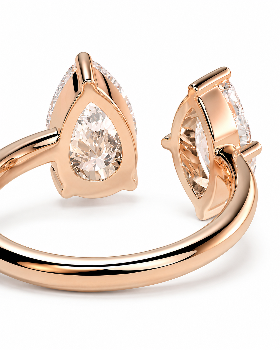 color_10K_RG, color_14K_RG &&Rose gold ring with pear-cut clear gemstones in a split setting, shown from two angles on a white background.