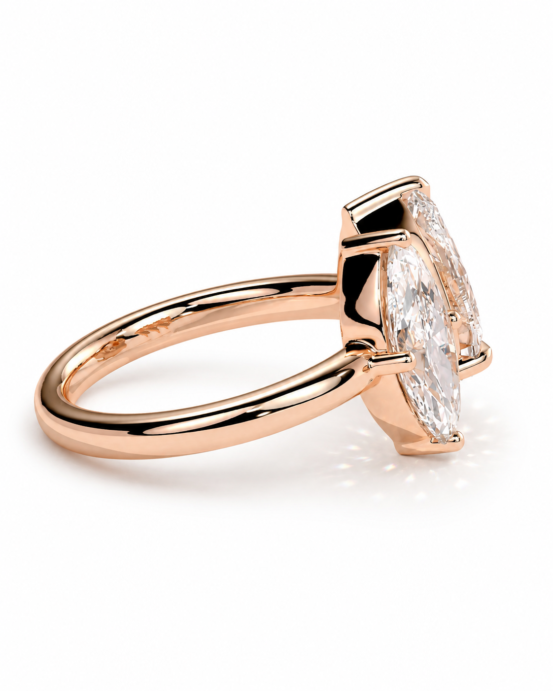 color_10K_RG, color_14K_RG &&A rose gold ring featuring a marquise-cut clear gemstone in a prong setting, shown on a clean white background.