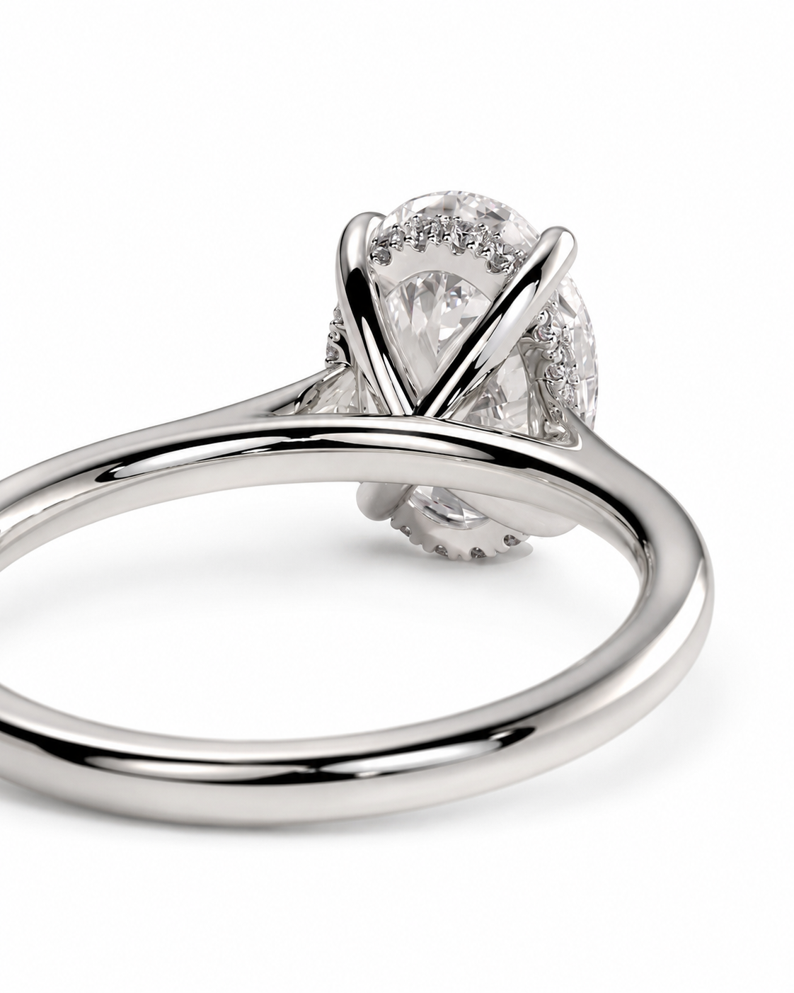 color_925_SIL,color_935_ARG,color_10K_WG, color_14K_WG &&A close-up shot of a silver-toned diamond ring with a pear-cut center stone and small accent diamonds, set in a polished four-prong setting on a white background.
