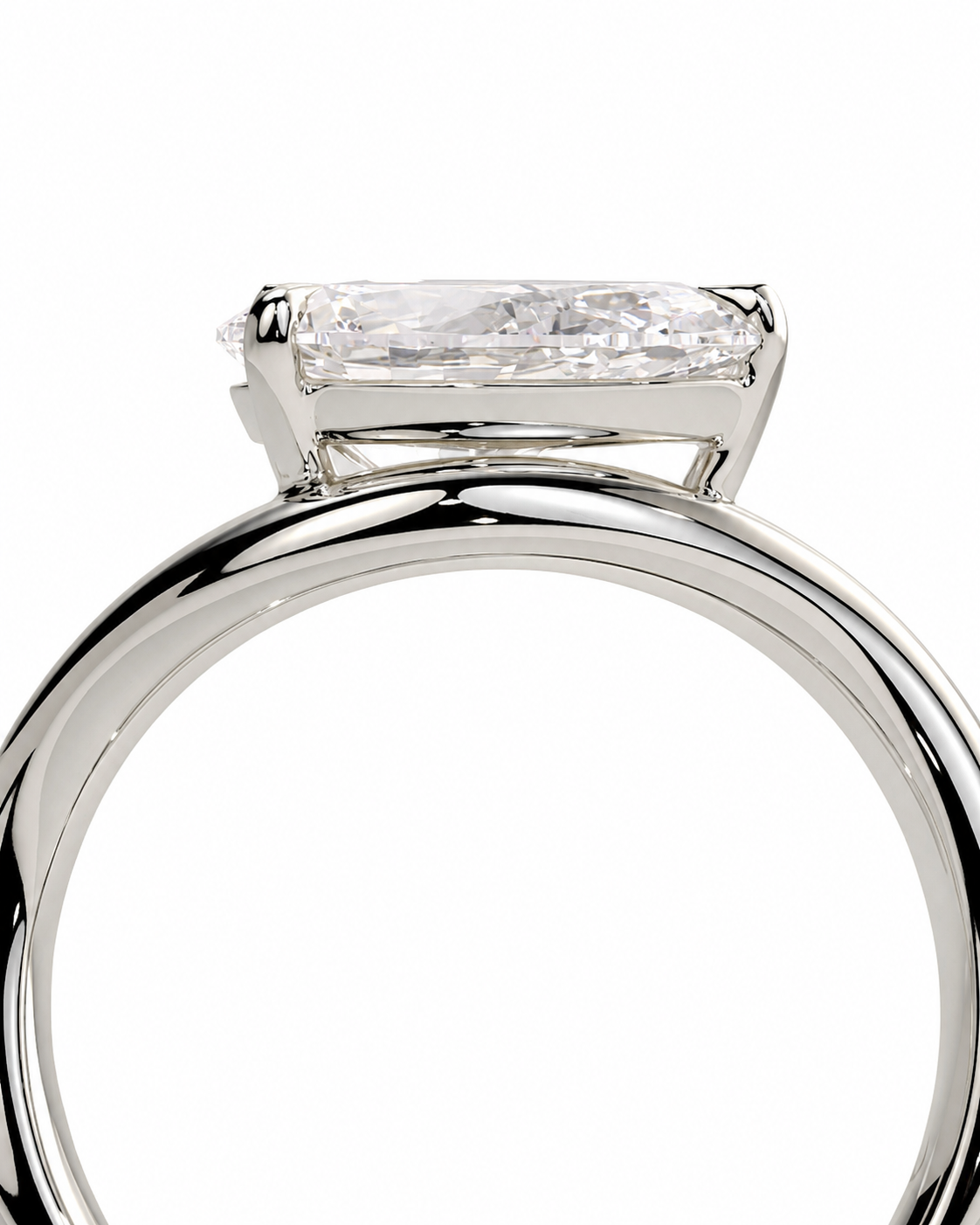 color_925_SIL,color_935_ARG,color_10K_WG, color_14K_WG &&A close-up studio shot of a silver-toned ring with a rectangular baguette-cut clear gemstone in a four-prong setting, shown against a plain white background.