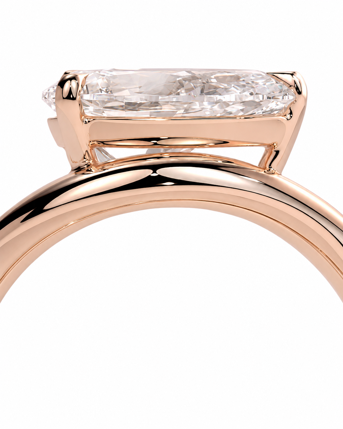 color_10K_RG, color_14K_RG &&Close-up of a rose gold ring with a rectangular baguette-cut clear gemstone in a four-prong setting, shown against a plain white background.