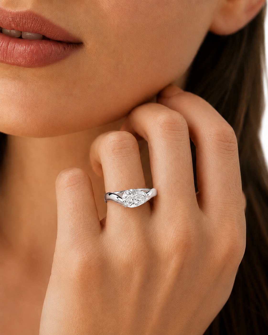 color_925_SIL,color_935_ARG,color_10K_WG, color_14K_WG &&A close-up lifestyle shot of a woman wearing a silver ring with a marquise-shaped cluster of clear stones on her finger.
