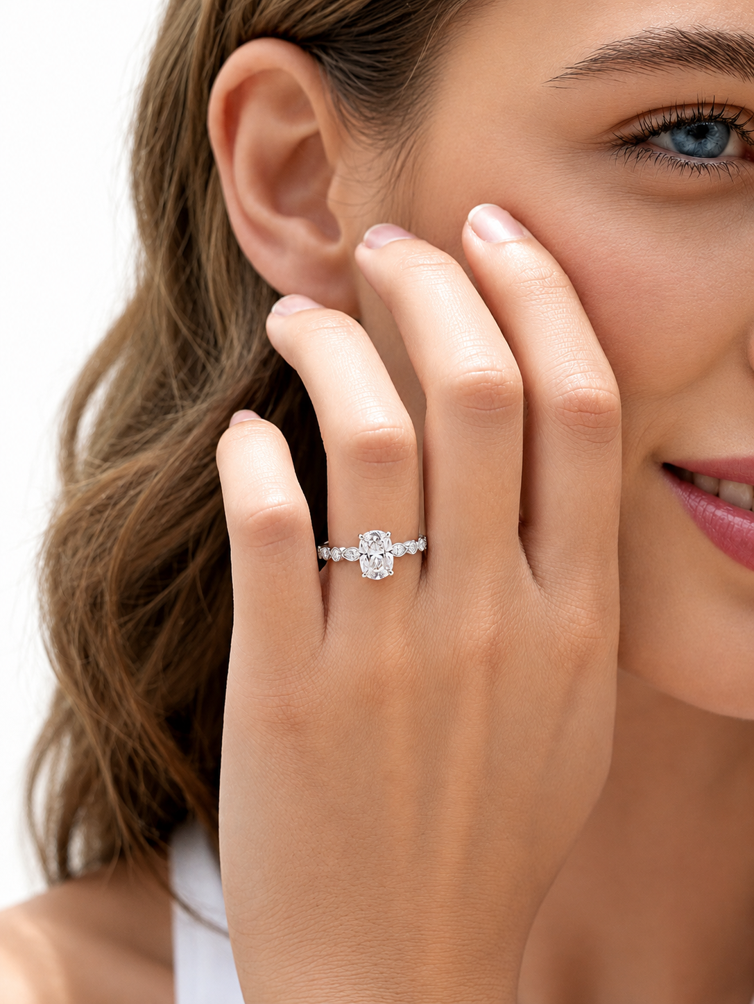 color_925_SIL,color_935_ARG,color_10K_WG, color_14K_WG &&
A close-up lifestyle shot of a woman wearing a silver-toned diamond ring on her finger, with her face partially visible against a clean white background.