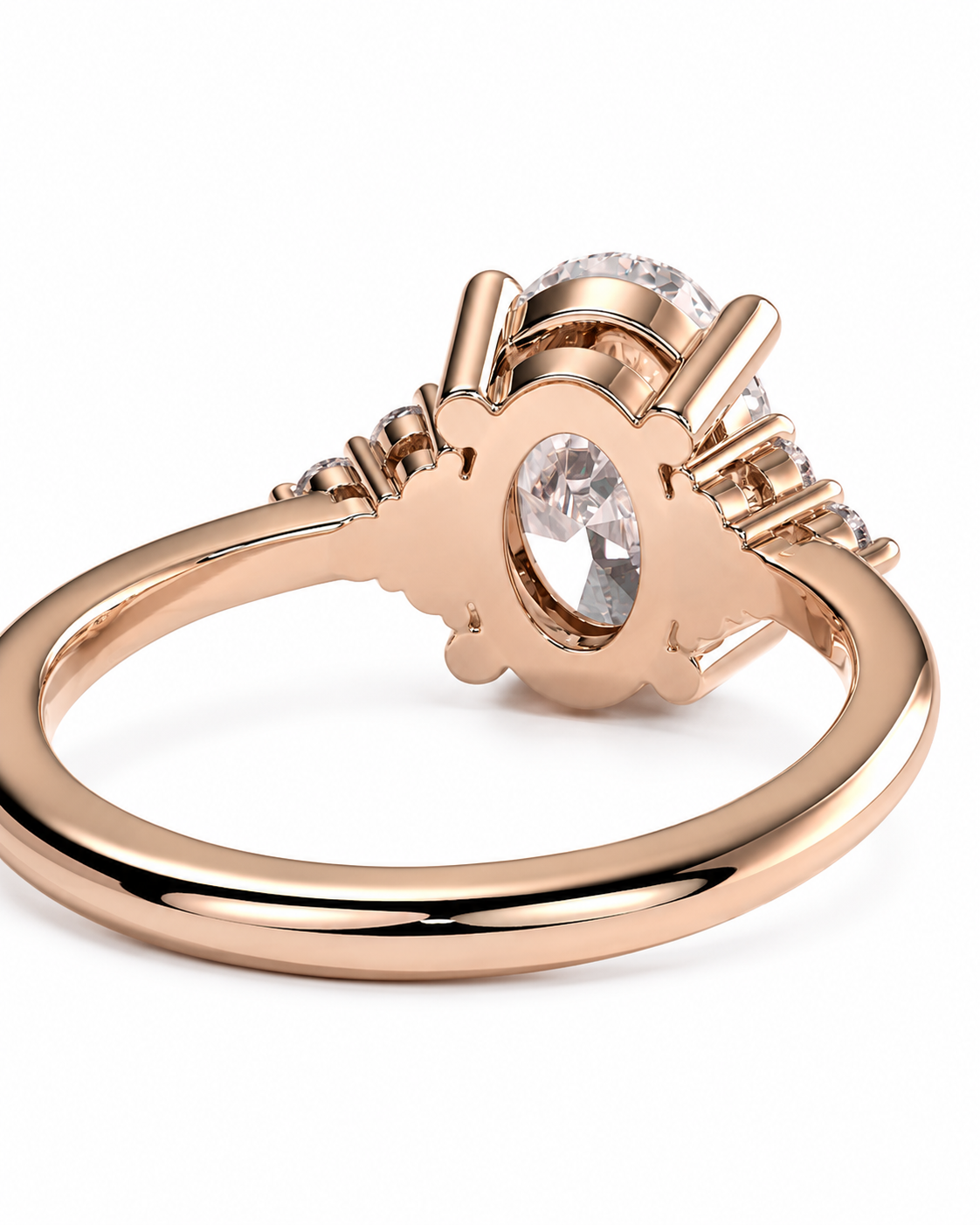 color_10K_RG, color_14K_RG &&Rose gold ring with a central oval clear gemstone and smaller side stones, shown on a clean white background.