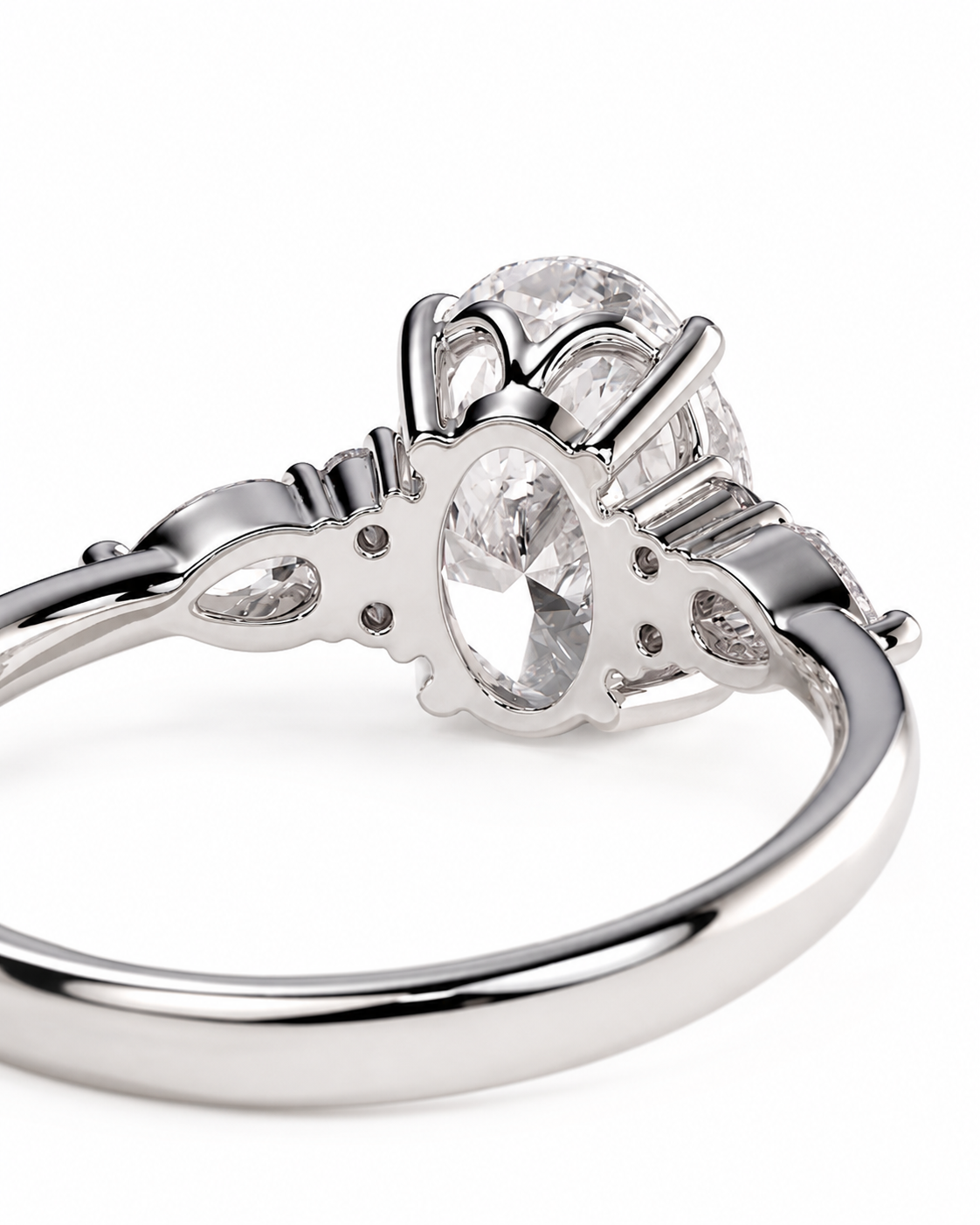 color_925_SIL,color_935_ARG,color_10K_WG, color_14K_WG &&A close-up studio shot of a silver-toned ring with a large oval clear gemstone and smaller accent stones on a white background.