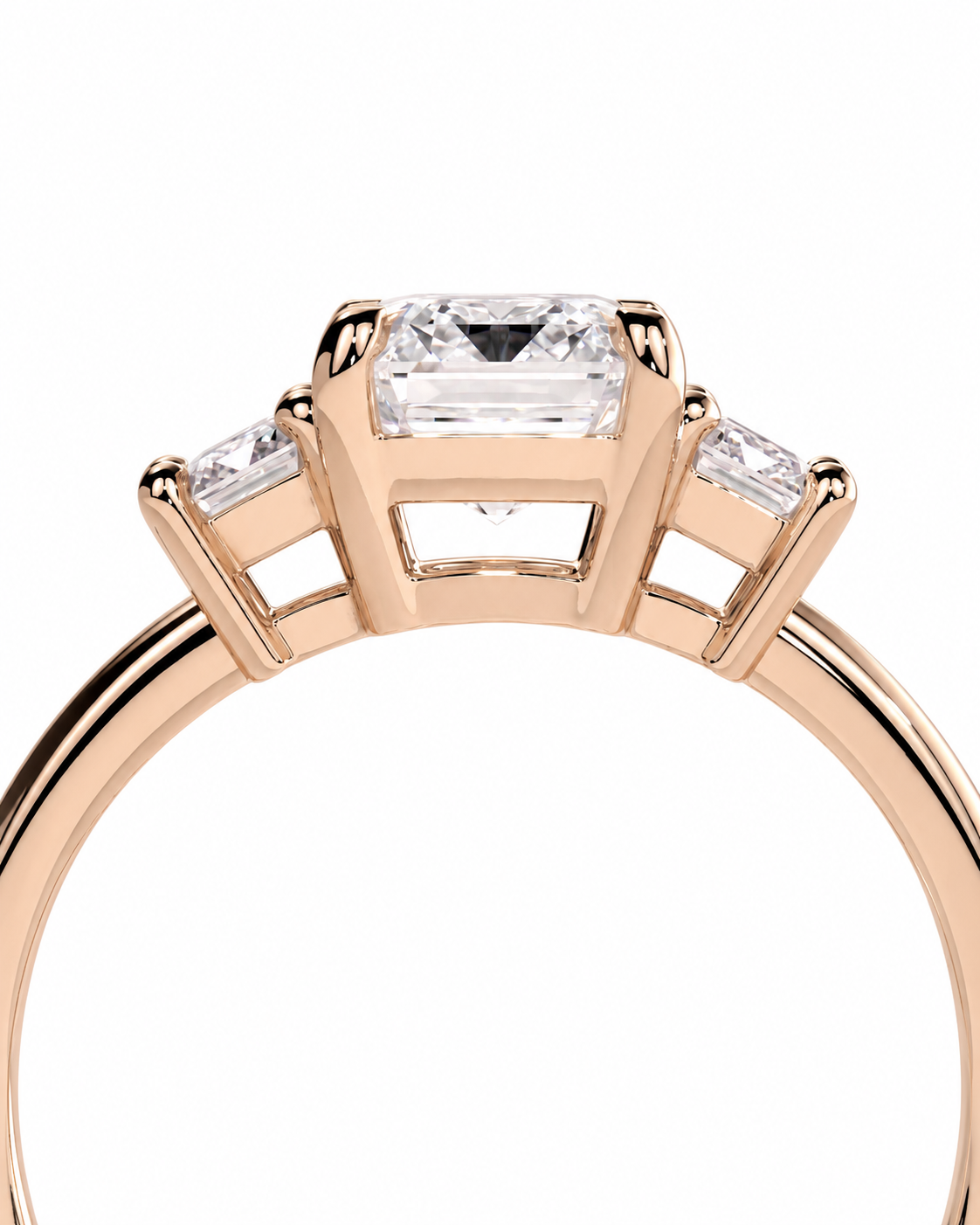 color_10K_RG, color_14K_RG &&Rose gold ring featuring a rectangular emerald-cut center stone with two smaller baguette-cut side stones, shown on a plain white background.