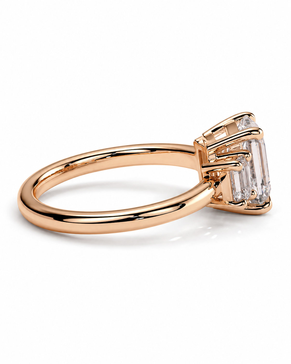 color_10K_RG, color_14K_RG &&A rose gold ring with a baguette-cut clear gemstone in a prong setting, shown on a clean white background.