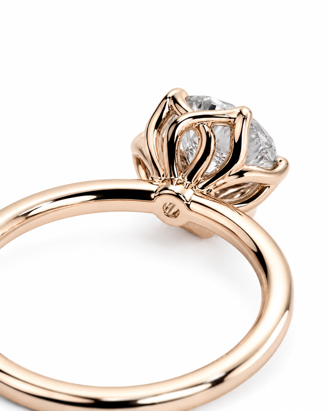 color_10K_RG, color_14K_RG &&A close-up of a rose gold ring with a floral crown setting and a clear round gemstone, shown on a plain white background.