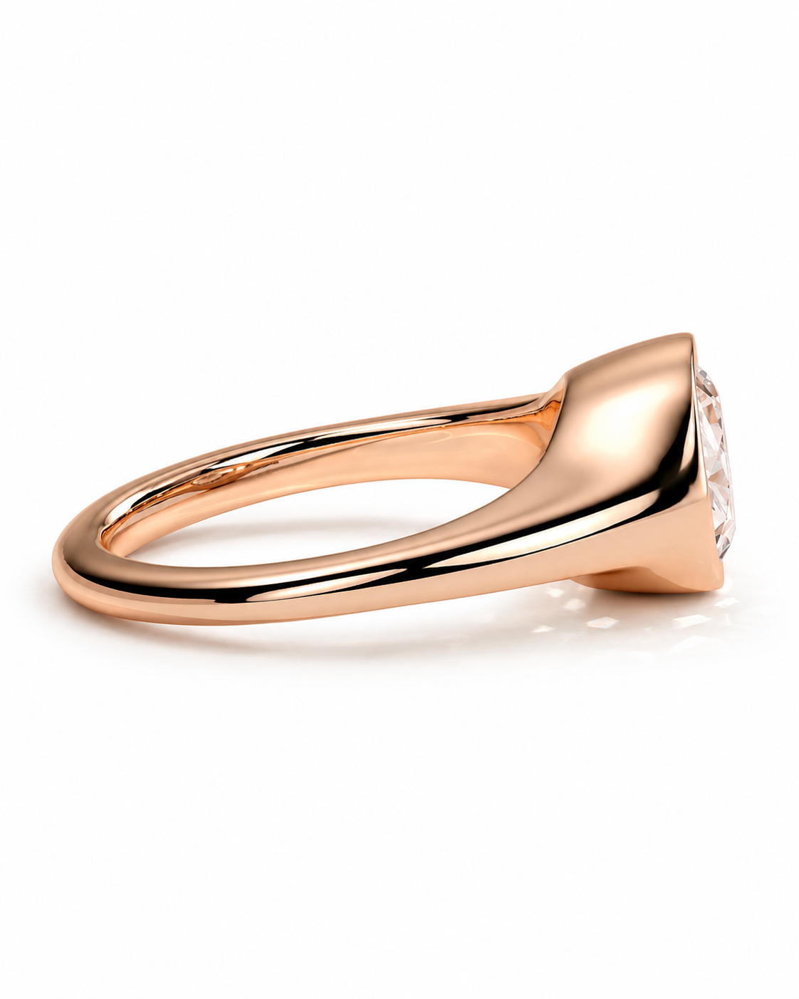 color_10K_RG, color_14K_RG &&A close-up side view of a rose gold ring with a tapered bezel setting and a clear gemstone, shown on a clean white background.
