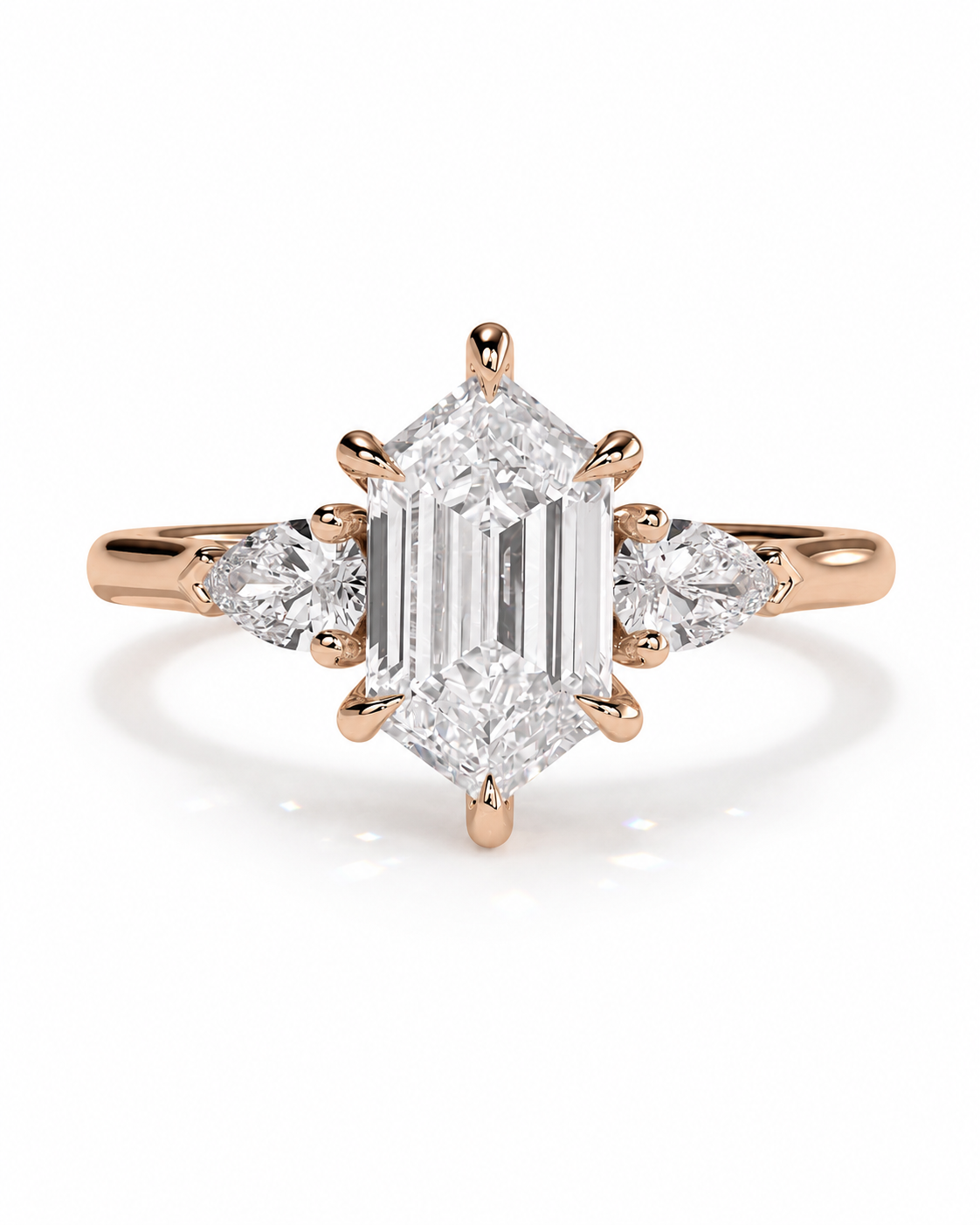 color_10K_RG, color_14K_RG &&A rose gold ring featuring a large emerald-cut center diamond flanked by two smaller round diamonds on a clean white background.