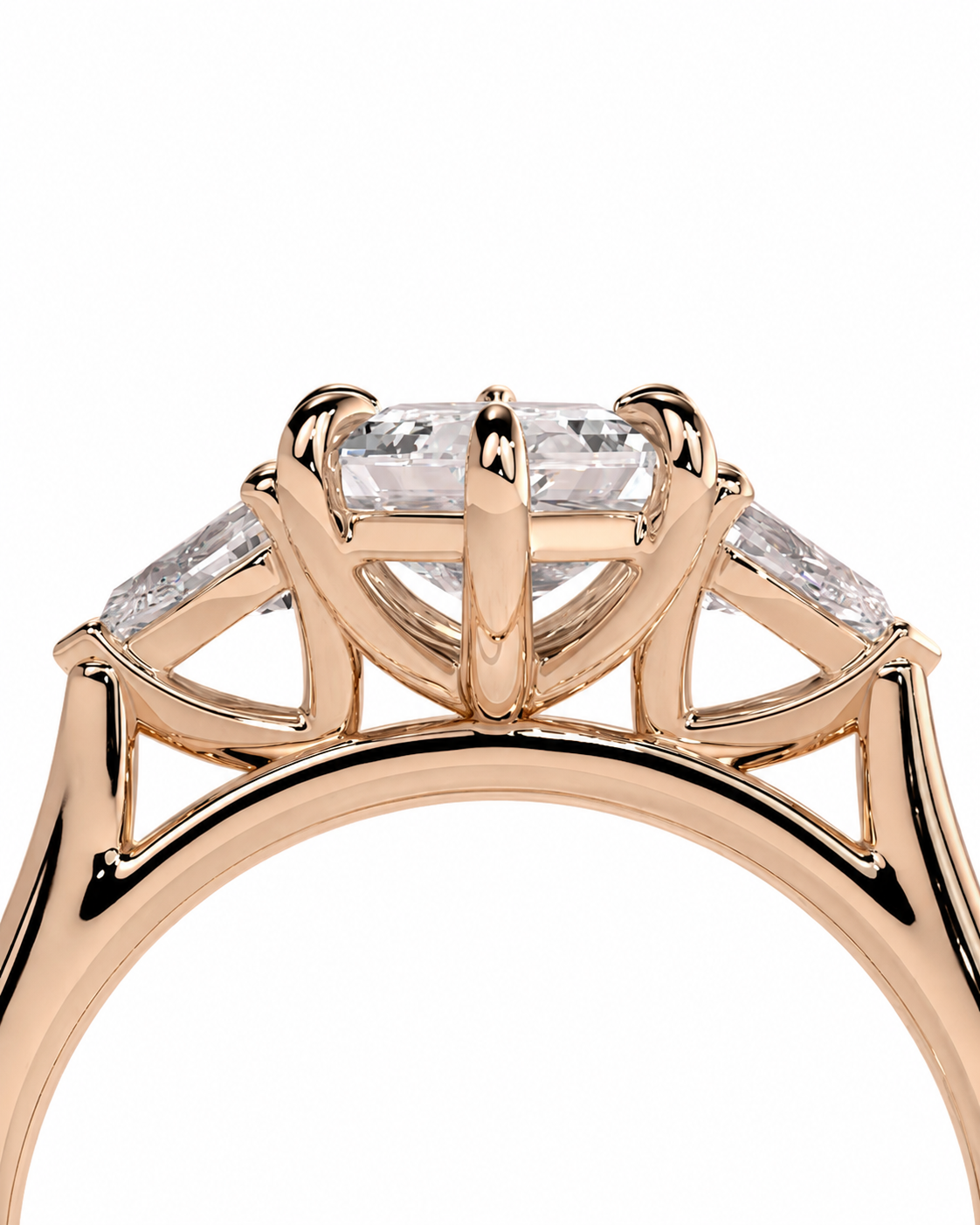 color_10K_RG, color_14K_RG &&Rose gold ring with a three-stone diamond solitaire setting, featuring a round center diamond and two marquise-cut side diamonds, shown against a white background.