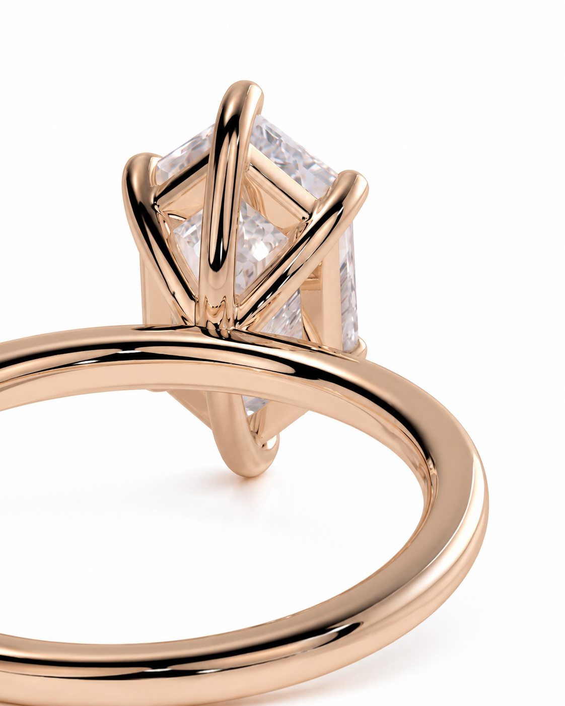 color_10K_RG, color_14K_RG &&
A close-up shot of a rose gold ring featuring a geometric, multi-prong setting with clear stones, shown against a plain white background.