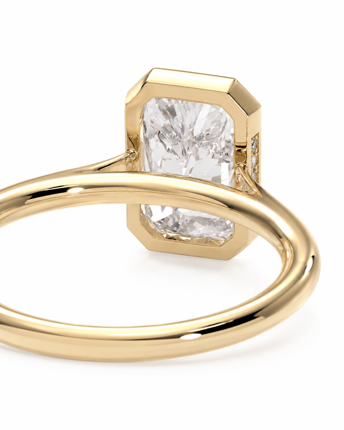 color_10K_YG, color_14K_YG &&A close-up shot of a yellow gold ring featuring a large rectangular emerald-cut clear gemstone in a beveled setting, with a polished band on a white background.