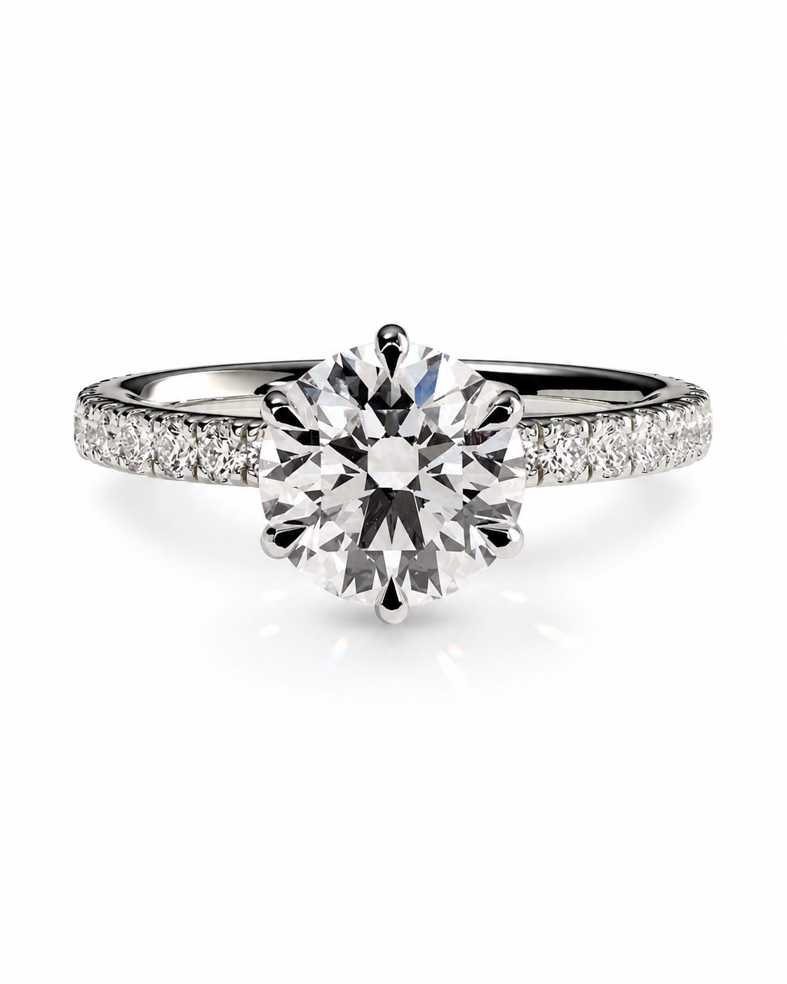 color_925_SIL,color_935_ARG,color_10K_WG, color_14K_WG &&A classic solitaire engagement ring featuring a round brilliant-cut center stone in a silver-toned setting, with a pavé band paved with small round stones, shown on a clean white background.