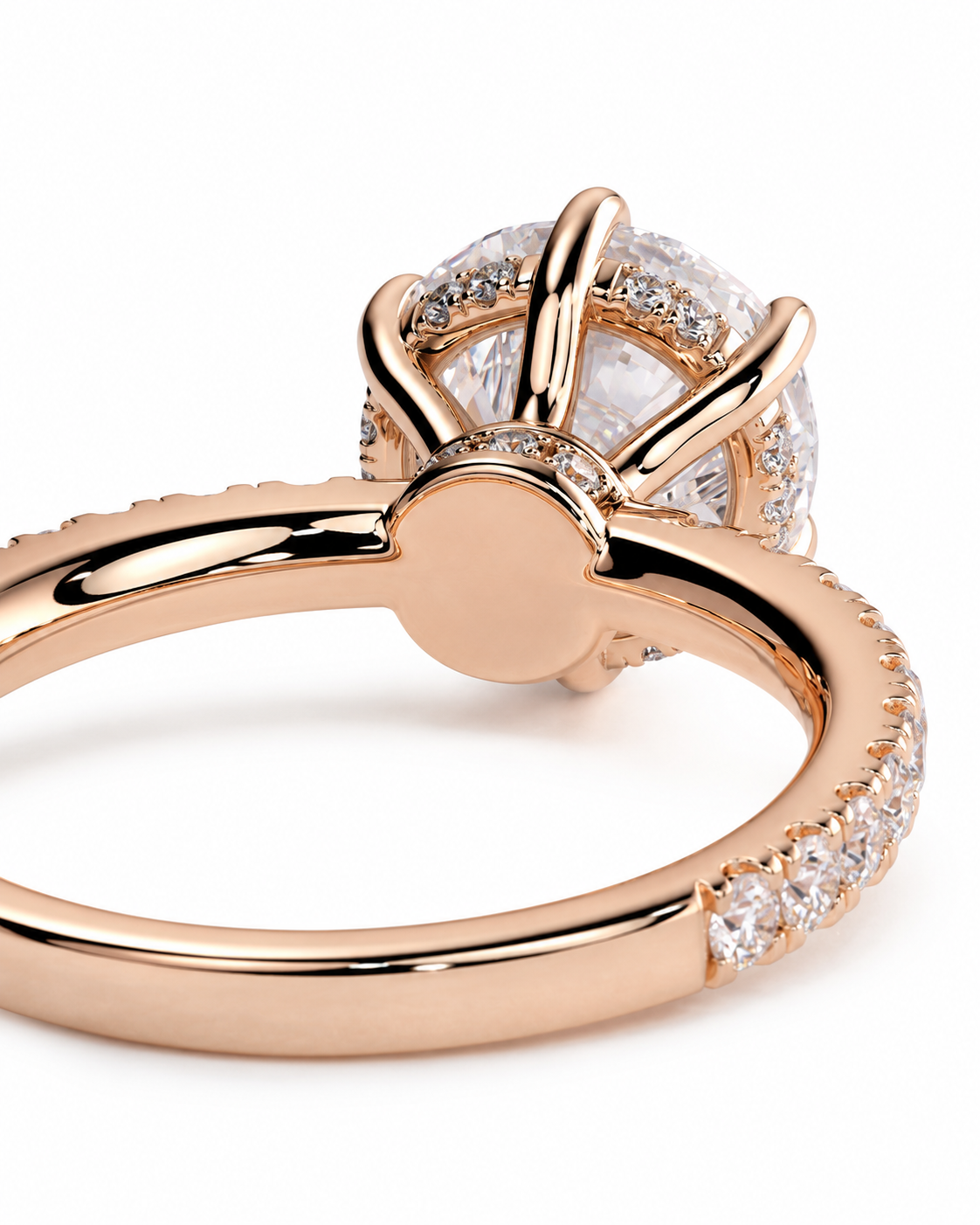 color_10K_RG, color_14K_RG &&Rose gold ring with a large round clear gemstone in a prong setting, accented with small pavé diamonds along the band, shown on a white background.