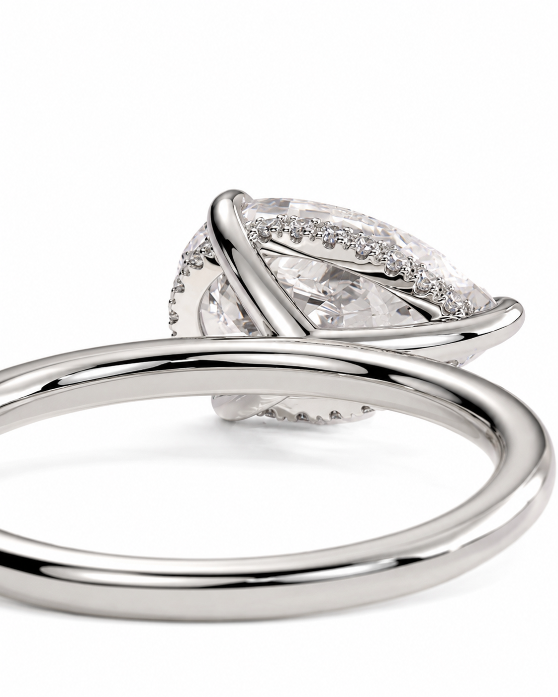 color_925_SIL,color_935_ARG,color_10K_WG, color_14K_WG &&A close-up of a silver ring featuring a marquise-cut clear gemstone surrounded by small pavé-set diamonds, with an intertwined band design, on a white background.