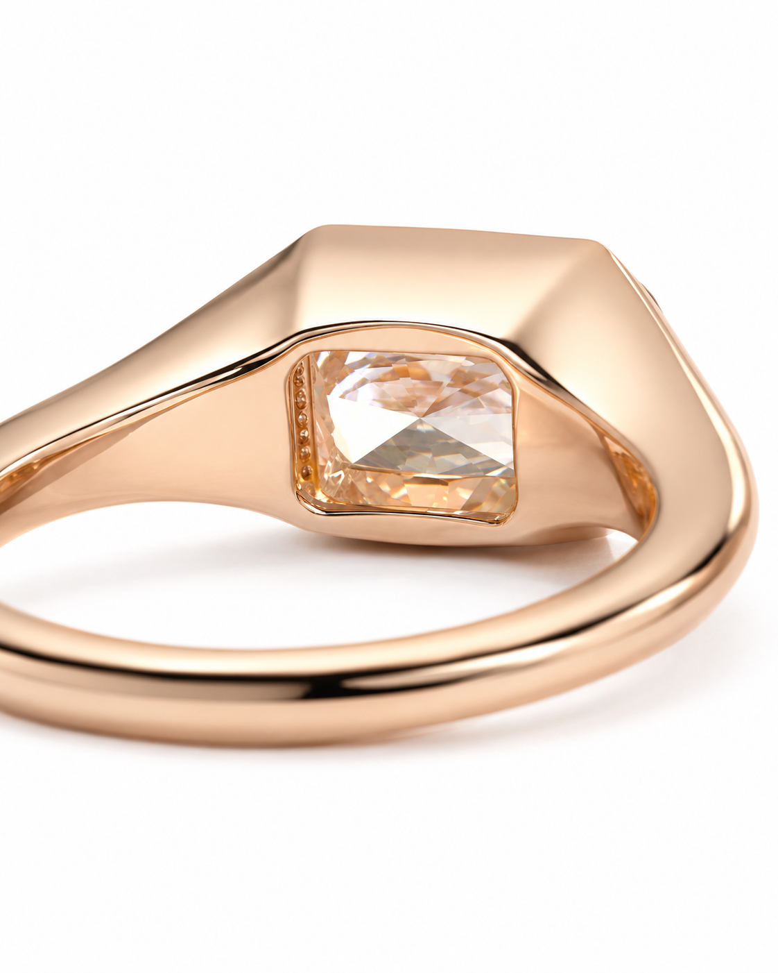 color_10K_RG, color_14K_RG &&A close-up of a rose gold signet ring with a square-cut clear gemstone on a white background.