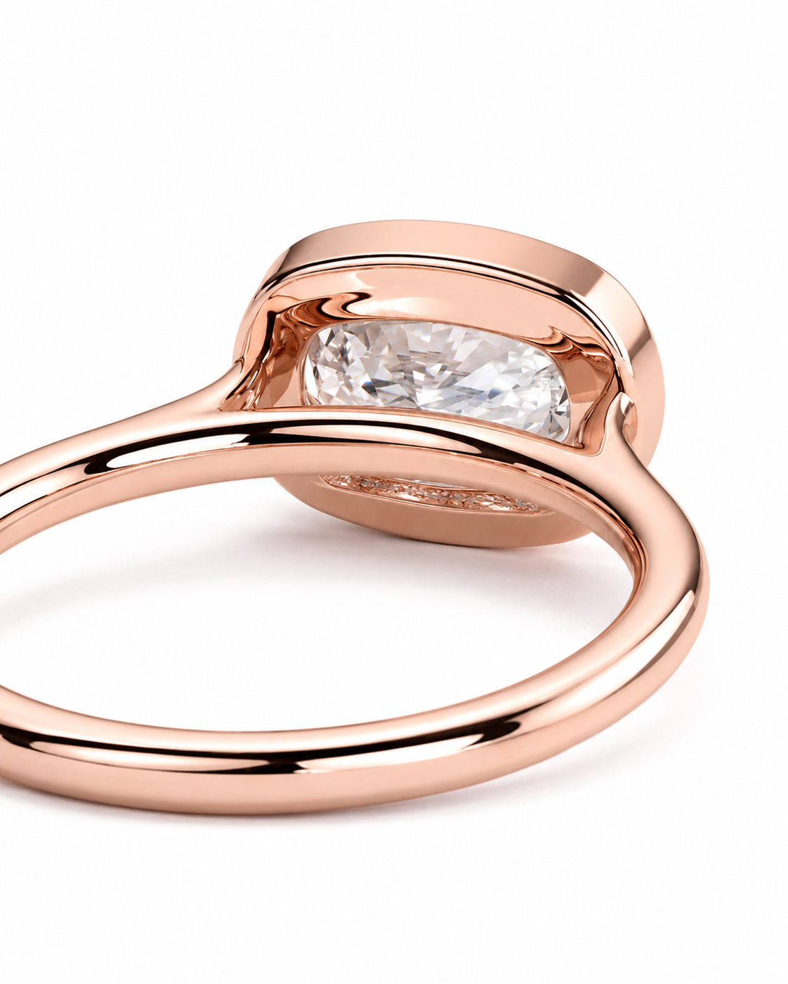color_10K_RG, color_14K_RG &&A close-up studio shot of a rose gold ring with a cushion-cut clear gemstone in a bezel setting, shown on a plain white background.