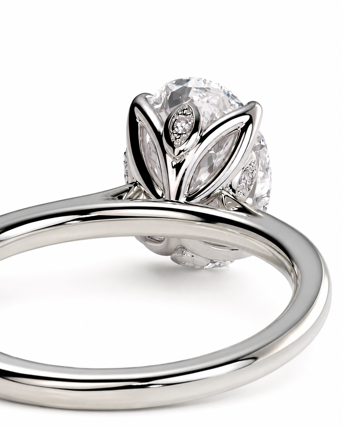 color_925_SIL,color_935_ARG,color_10K_WG, color_14K_WG &&A close-up studio shot of a silver-toned ring featuring a large clear round center stone surrounded by leaf-shaped and marquise-cut side stones, set on a polished band against a white background.