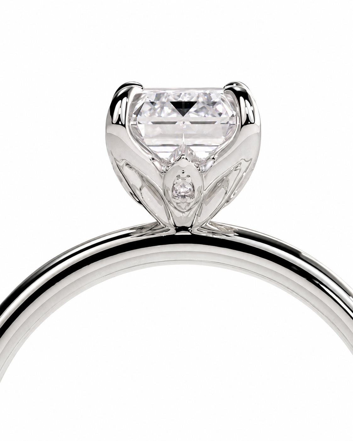 color_925_SIL,color_935_ARG,color_10K_WG, color_14K_WG &&A close-up studio shot of a silver-toned solitaire engagement ring with a clear rectangular-cut diamond and a small marquise-cut diamond accent, set against a plain white background.
