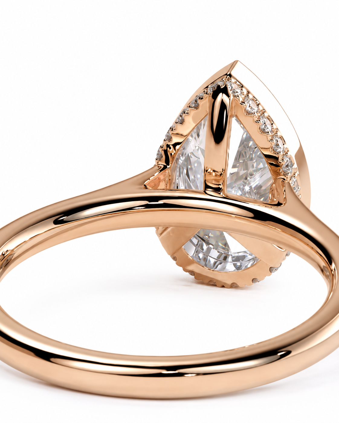 color_10K_RG, color_14K_RG &&Rose gold ring with a large teardrop-shaped clear gemstone and smaller accent stones, shown in a close-up studio shot on a white background.