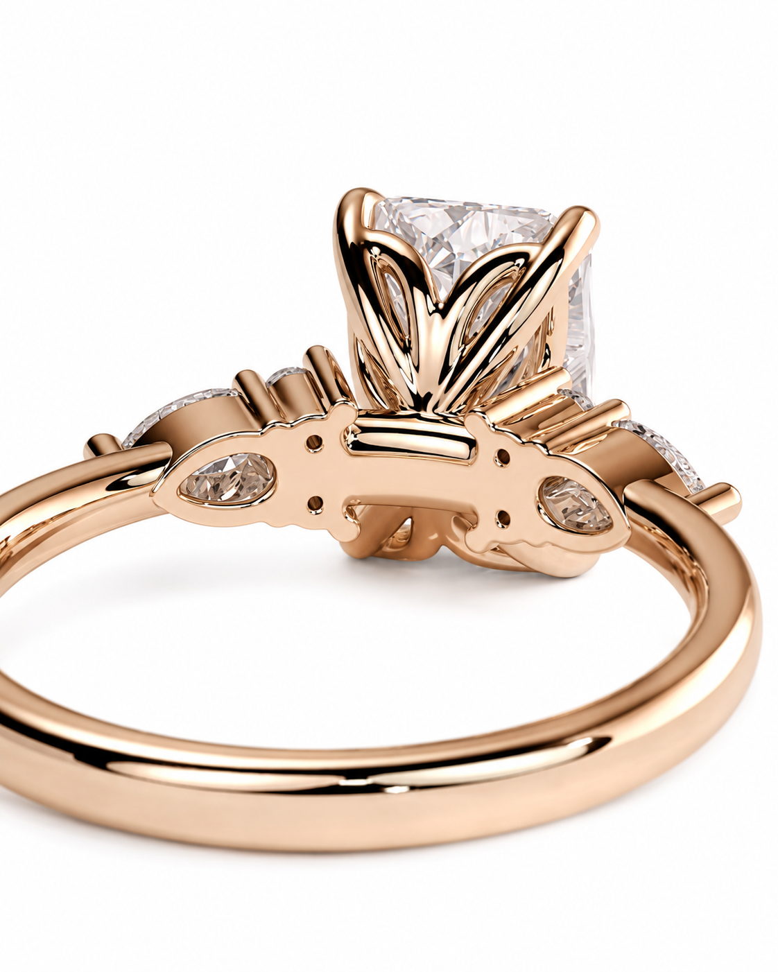 color_10K_RG, color_14K_RG &&A close-up shot of a rose gold ring with a large square clear gemstone in a decorative setting, accented by smaller side stones, on a white background.