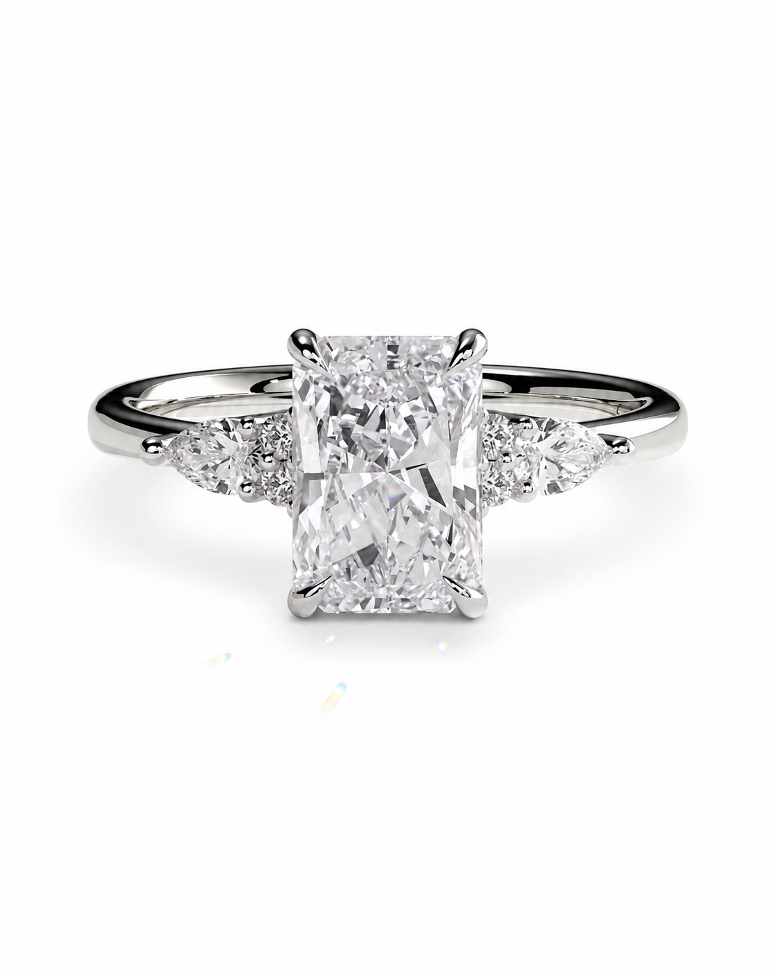 color_925_SIL,color_935_ARG,color_10K_WG, color_14K_WG &&An emerald-cut diamond engagement ring with a silver-toned band and small side diamonds, centered on a white background.
