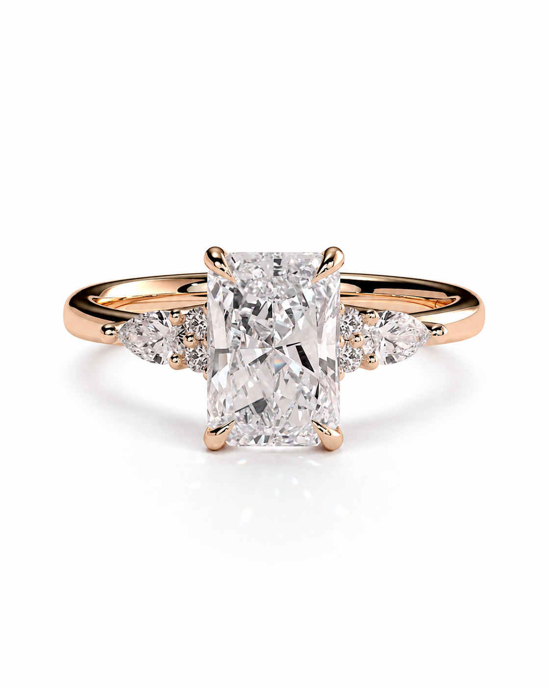 color_10K_RG, color_14K_RG &&A rose gold engagement ring featuring a large rectangular emerald-cut center diamond flanked by smaller round and marquise-cut side diamonds on a clean white background.