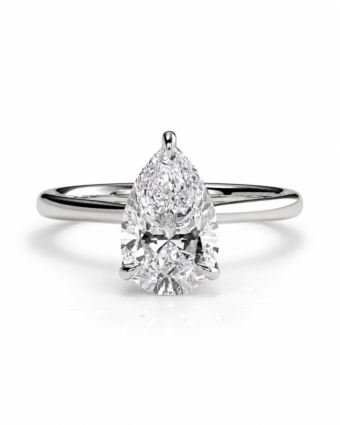 color_925_SIL,color_935_ARG,color_10K_WG, color_14K_WG &&A pear-cut diamond engagement ring with a polished silver-colored band, shown on a clean white background.
